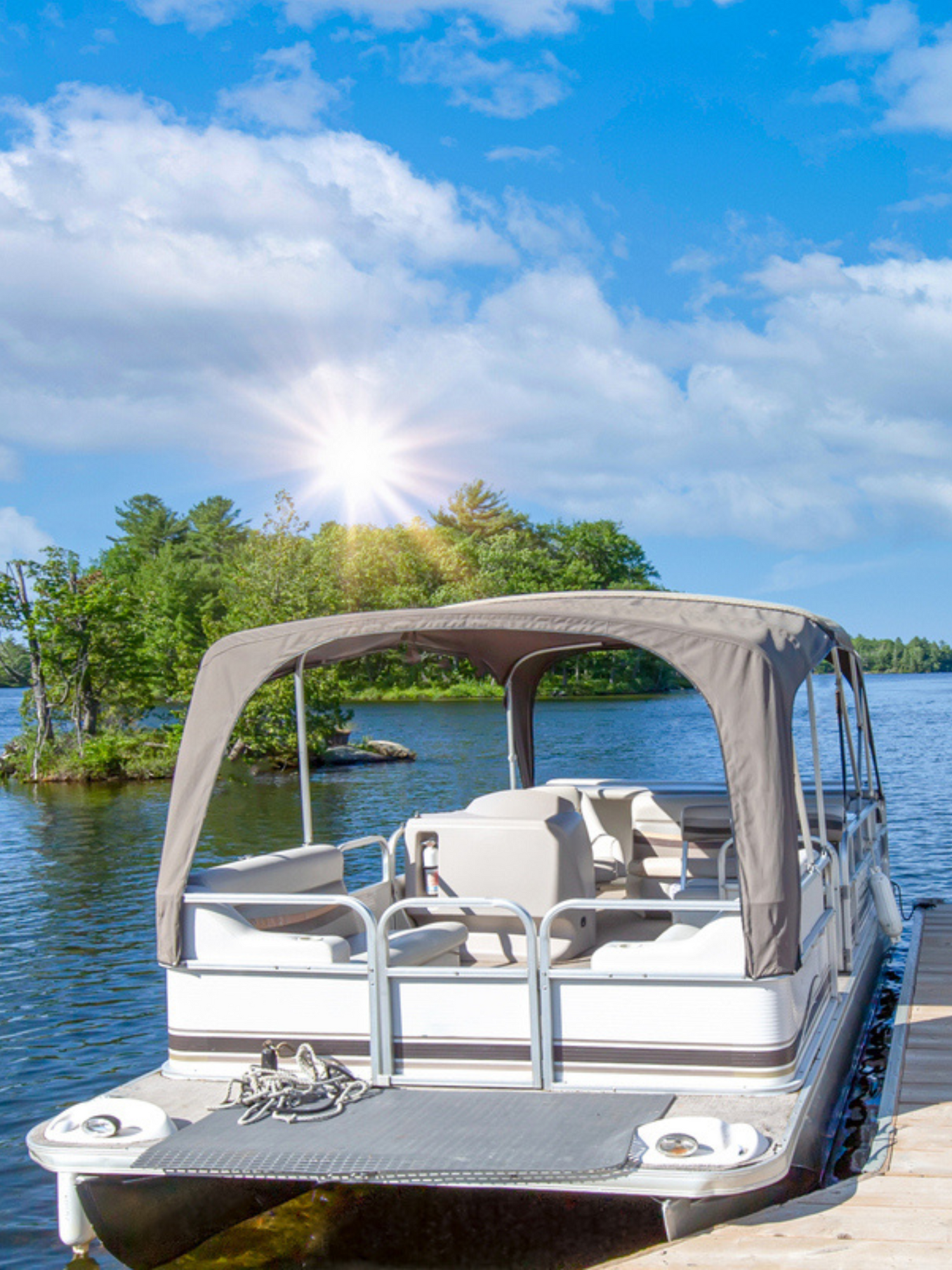 pontoon boat parked at a dock in a lake