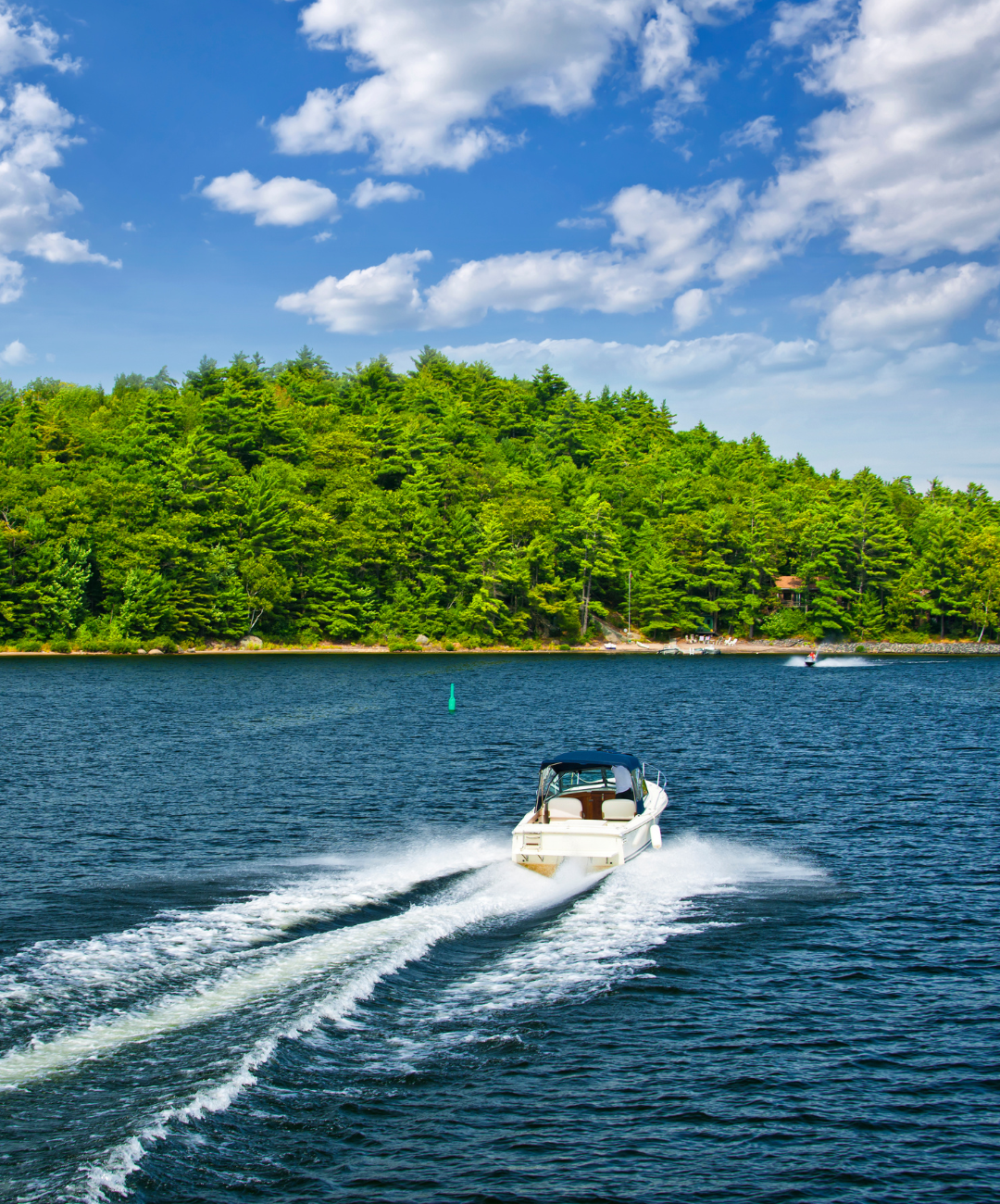 white boat sailing away in a lake