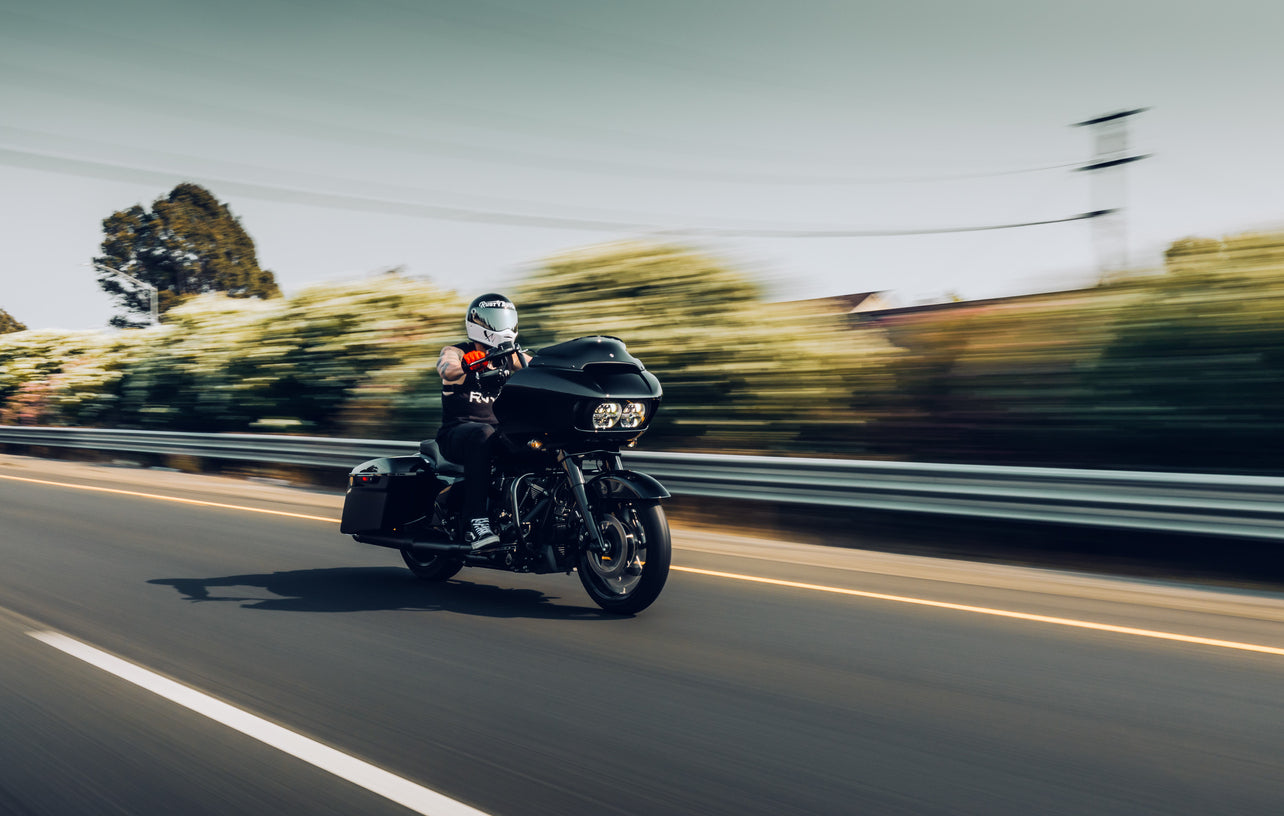 black motorcycle driving down a highway