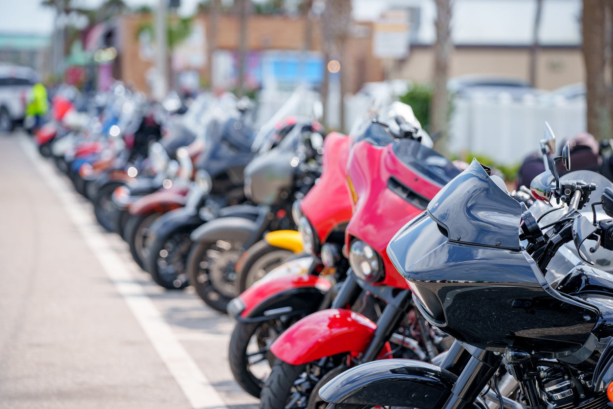 group of bagger motorcycles parked on side of the street