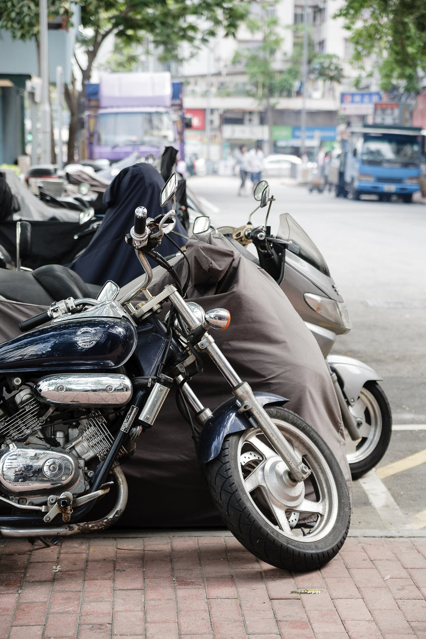 row of motorcycles parked next to each other on a street